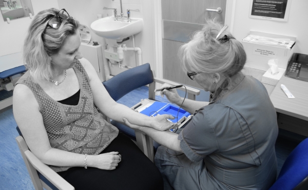 Nurse doing procedure in pain clinic