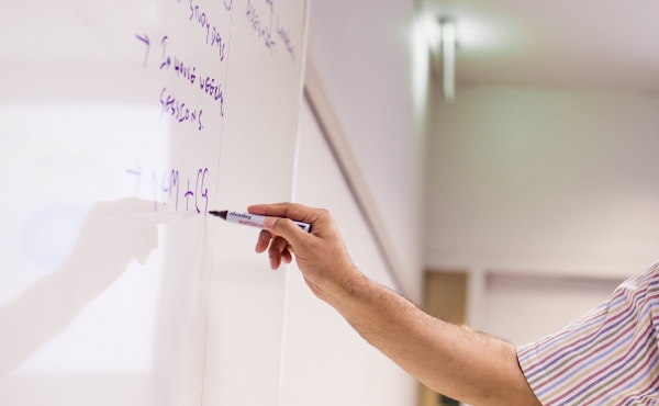 Photo of a hand drawing on a whiteboard