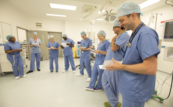 Photo of doctors smiling in a row in scrubs