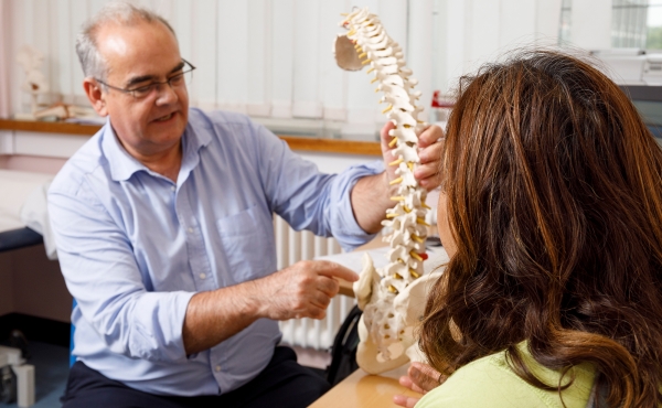 Clinician shows spine model